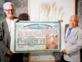 Yew Lee shows his father's Head Tax Certificate to Roy Atkinson